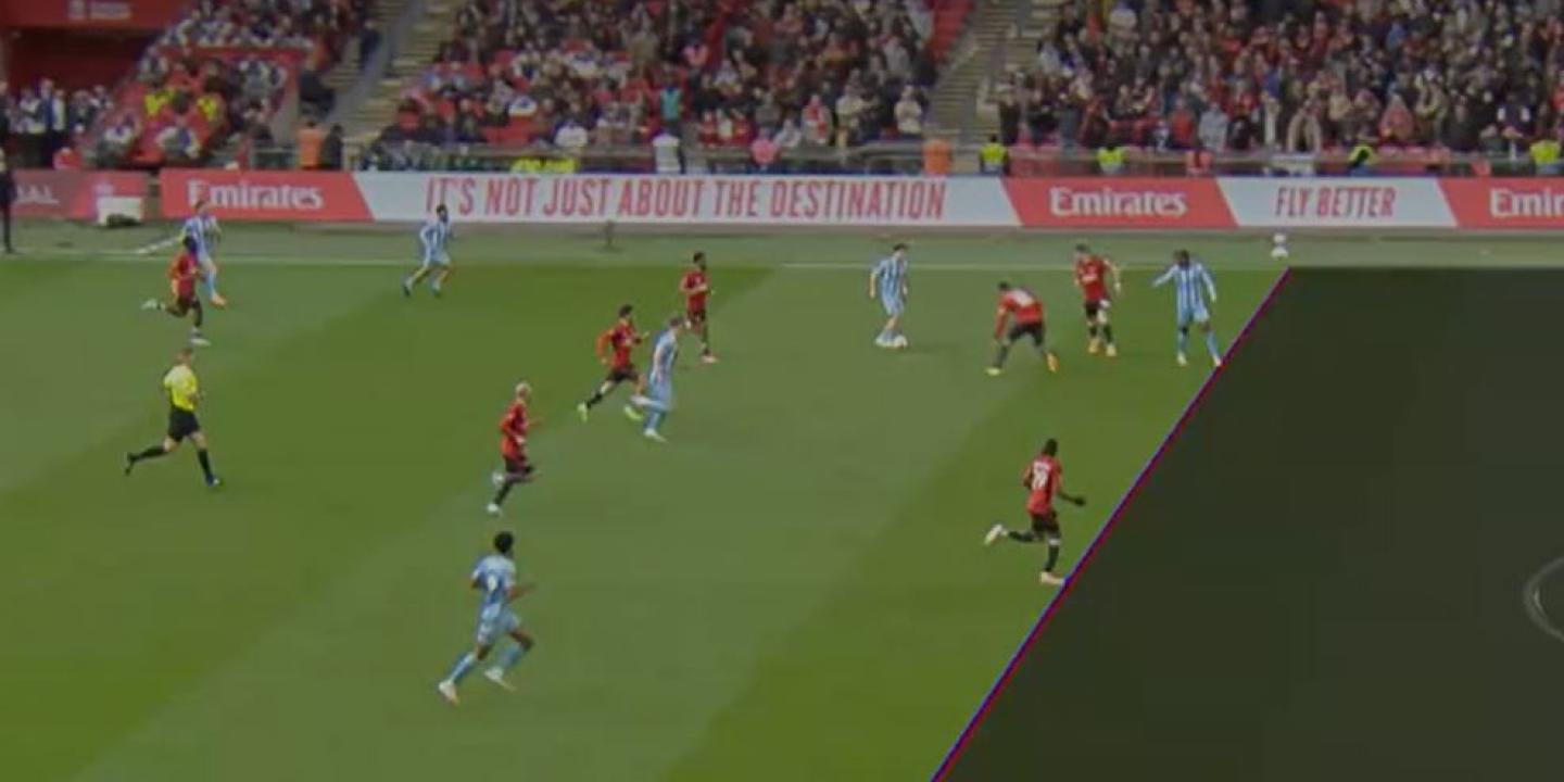 A TV screen shows a football match with a superimposed diagonal line dividing the pitch.