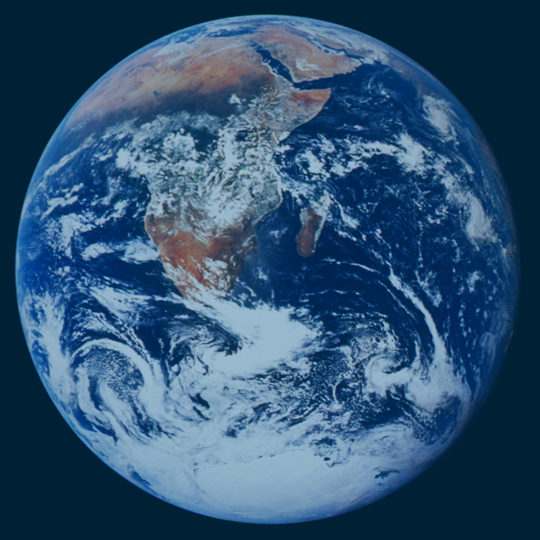 Planet Earth viewed in totality from space. Africa and Arabia are visible under some cloud in the south.