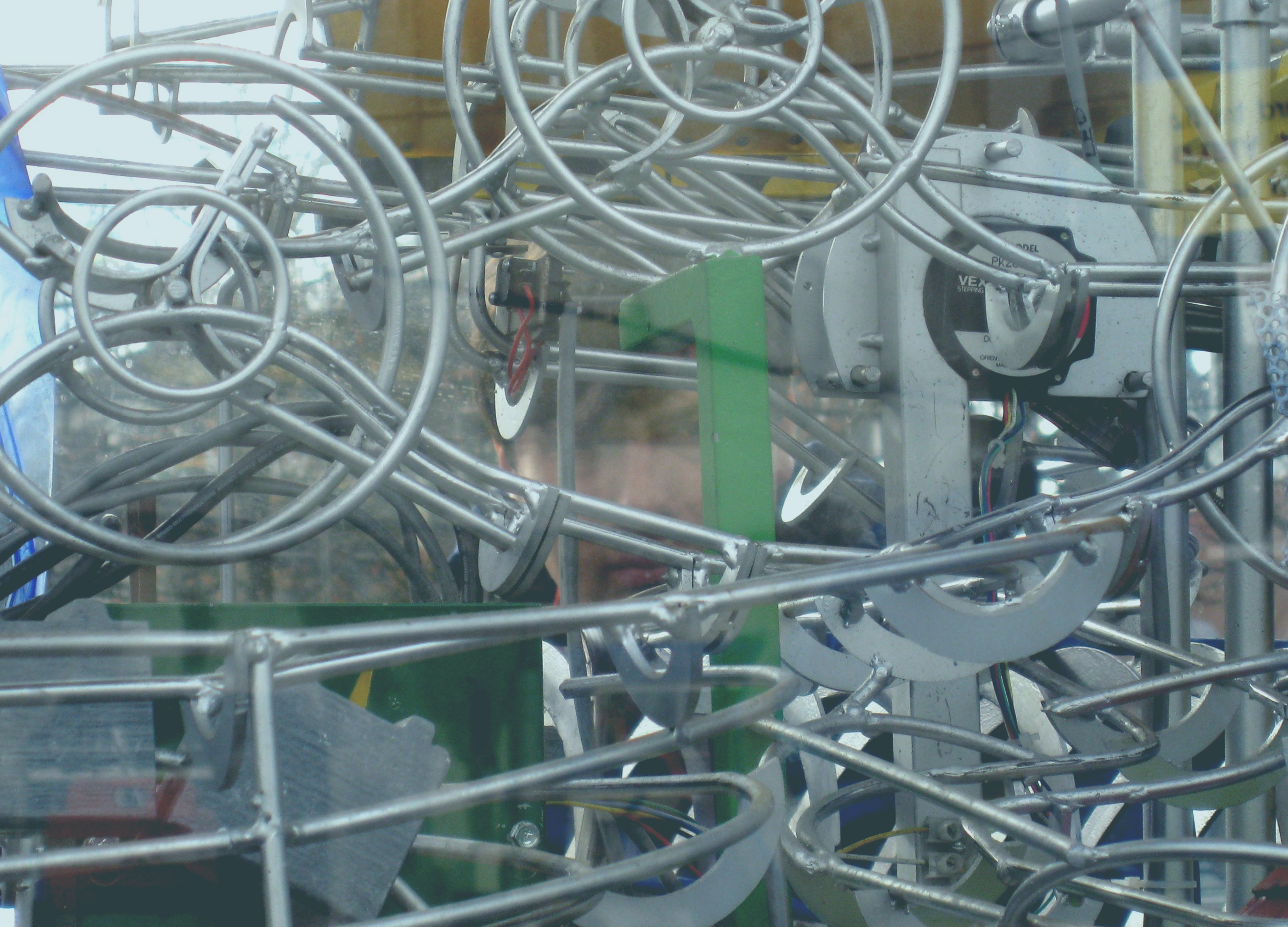 A complex of linear and metal parts in a machine-like sculpture.