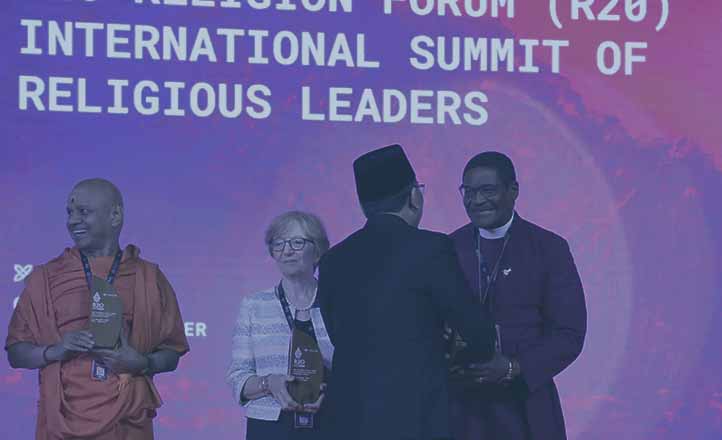 Swami Govinda Dev Giri Maharaj, Dr. Valeria Martano, and Archbishop Henry Ndukuba, are greeted by R20 founder Yahya Cholil Staquf.