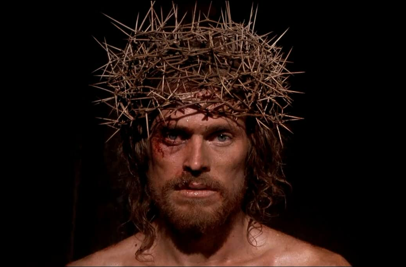 Jesus, scared and wearing a crown of thorns, looks directly into the camera.
