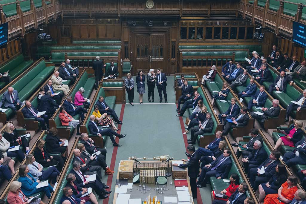 an aerial view down in to the parliamentary chamber shows MPs sitting on benches on the left and right hand side