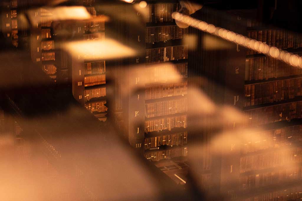 An unfocused views down on to stacks of books in an old library.