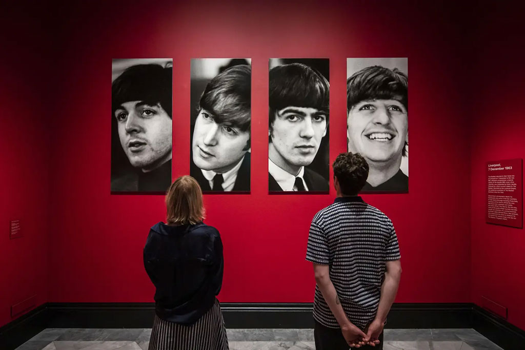 Two gallery vistor stair at four photo portraits of The Beatles.