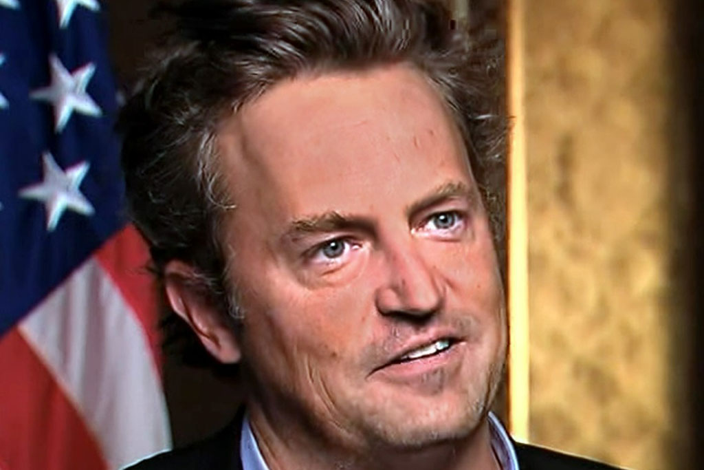 Actor Matthew Perry looks formally away, with a US flag in the background
