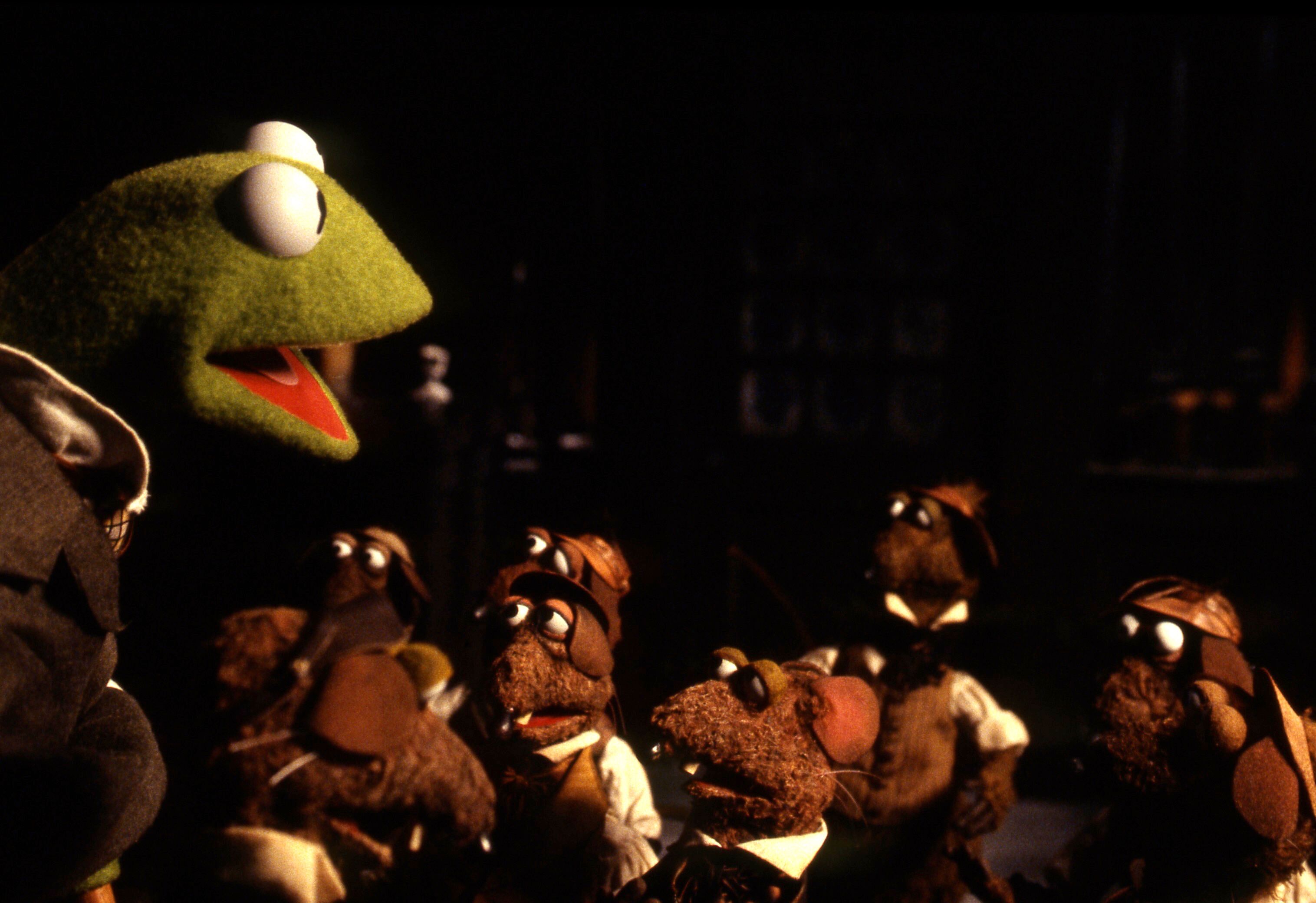 Kermit, a frog talks to rats dressed as Victorian children.