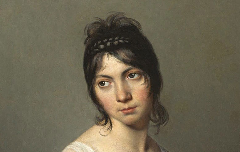 A head and shoulders portrait of a young woman inclining her gaze to one side.