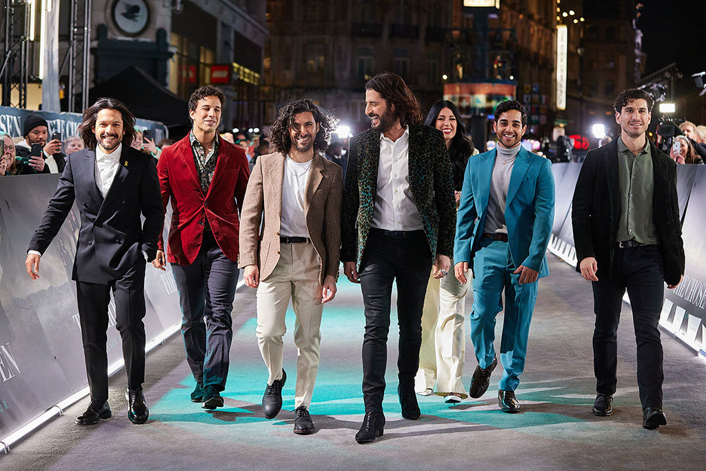 A group of actors walk together at a film premiere
