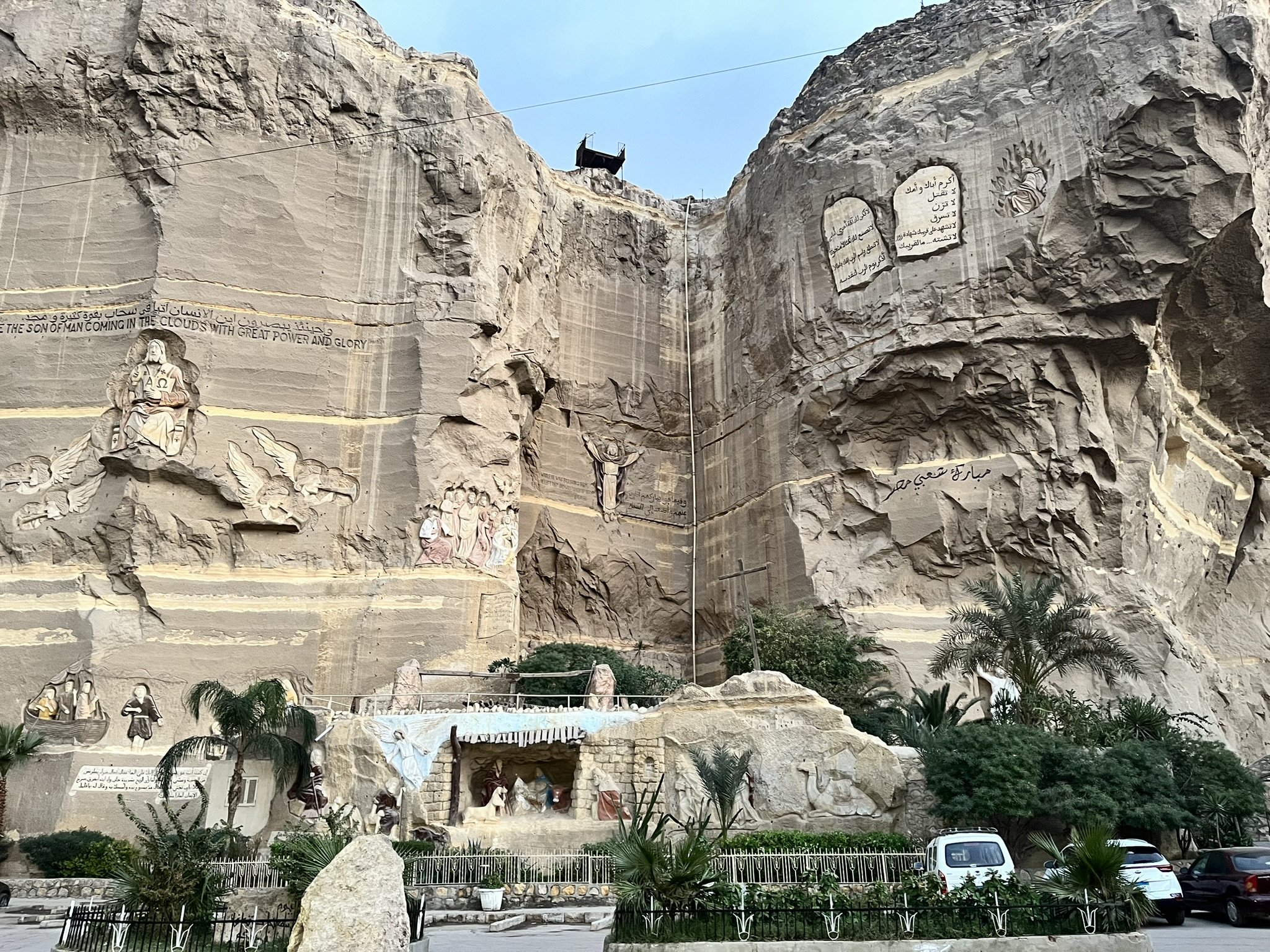 a cliff with carved and painted Christian scenes.