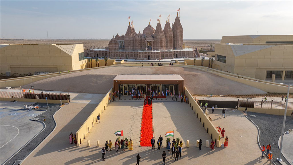 A red carpet lies on a grand entrance to a newly constructed Hindu temple.