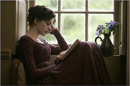 A woman in 18th century clothes sits within a windowsill reading a book