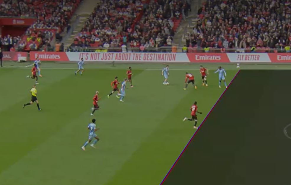 A TV screen shows a football match with a superimposed diagonal line dividing the pitch.