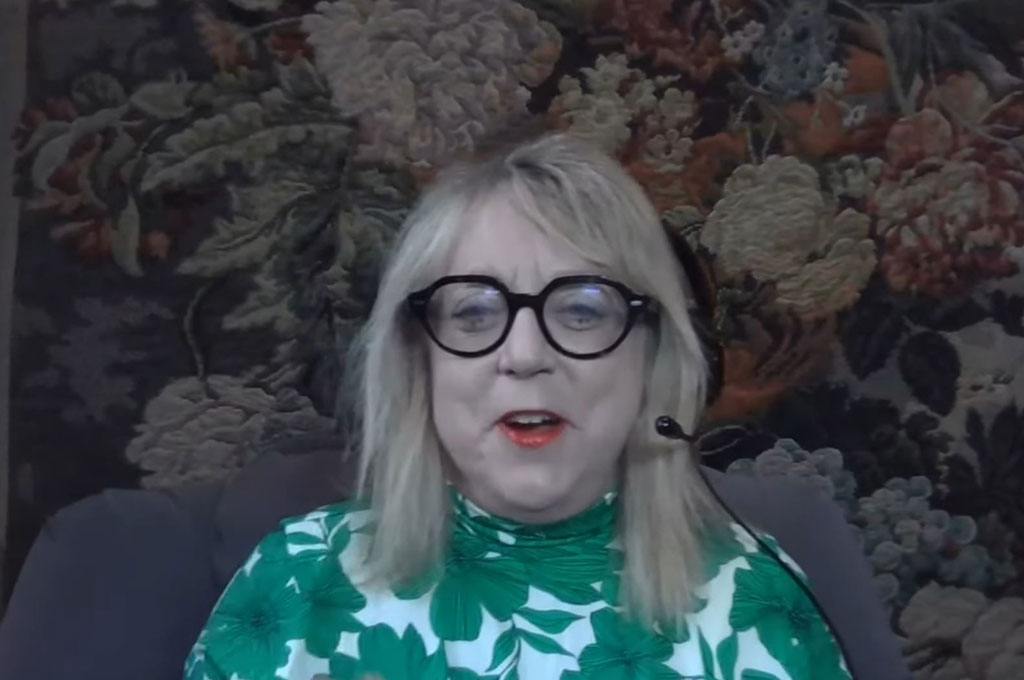 A woman guest on a podcast laughs.