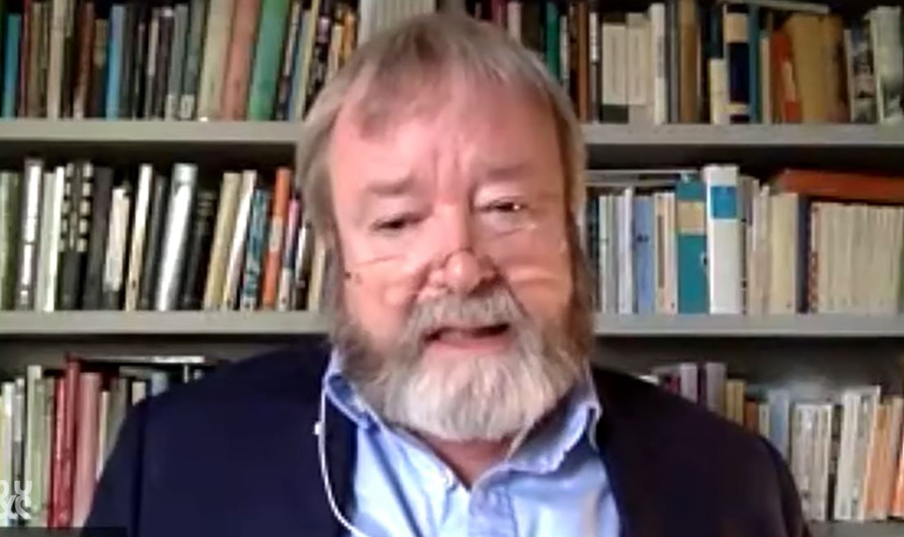 A man sits and talks to the camera.