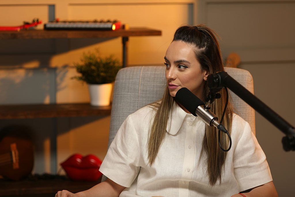 A podcast guest speaks in front of a mic.