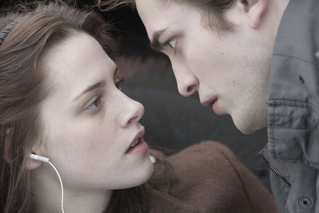 A modern vampire stairs at the face of his girlfried.