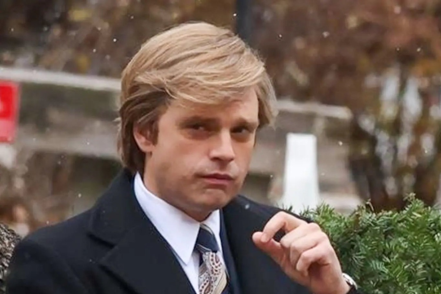 An 1980s business man looks contemptuously at the camera.