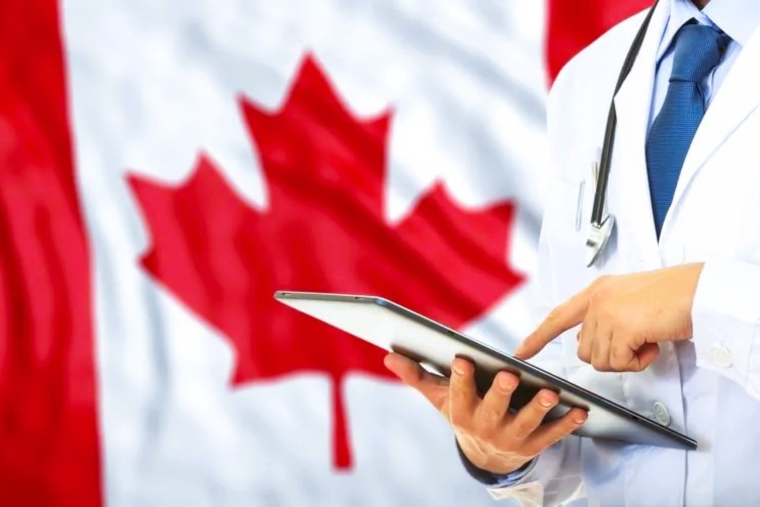 a doctor consults a tablet against the backdrop of a Canadian flag.