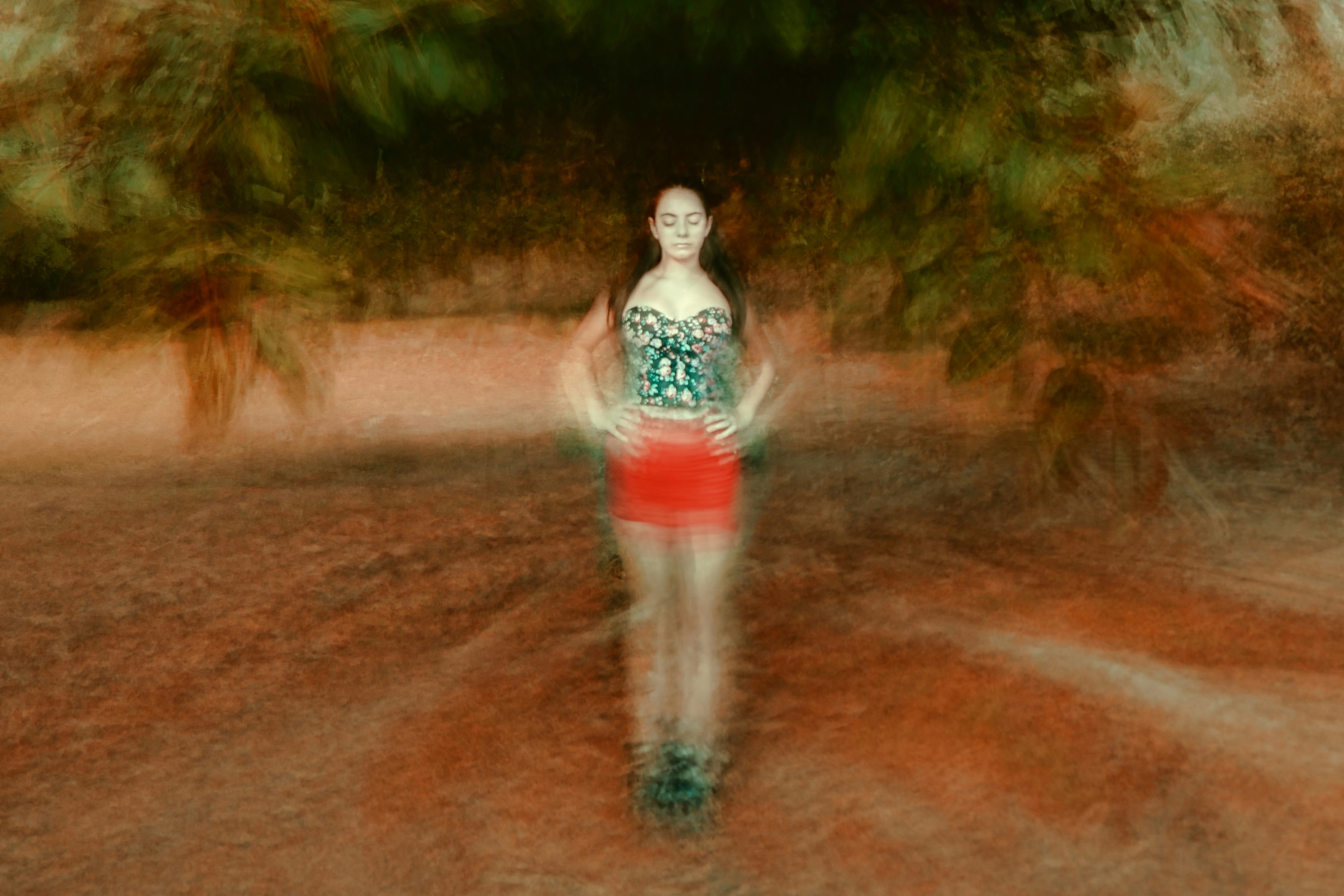 A montage image places a woman, with eyes shut and hands on hip, at the centre of blurred circle of ground and tree branches.