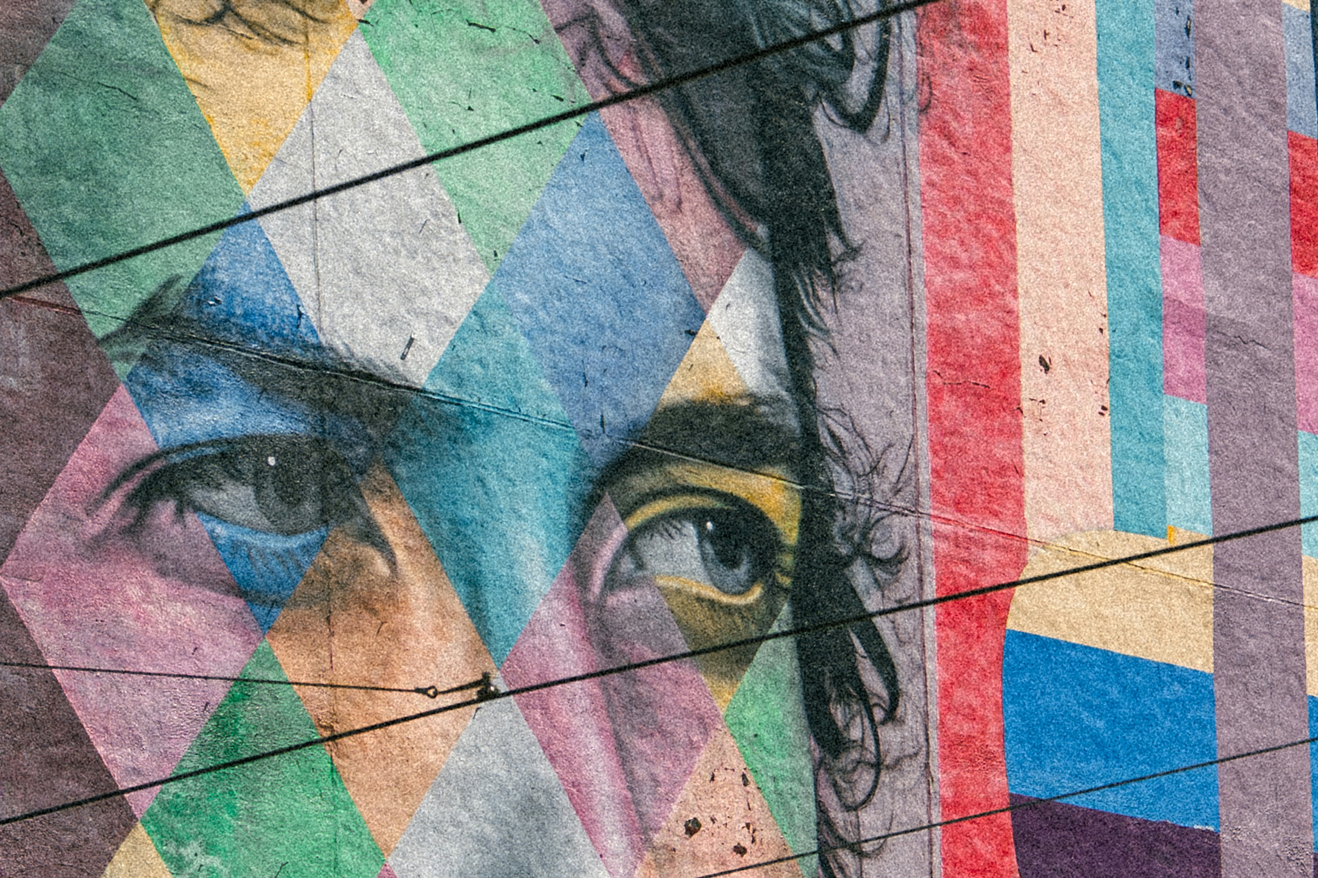 A colorful mural depicts the eyes of Bob Dylan staring to the side.