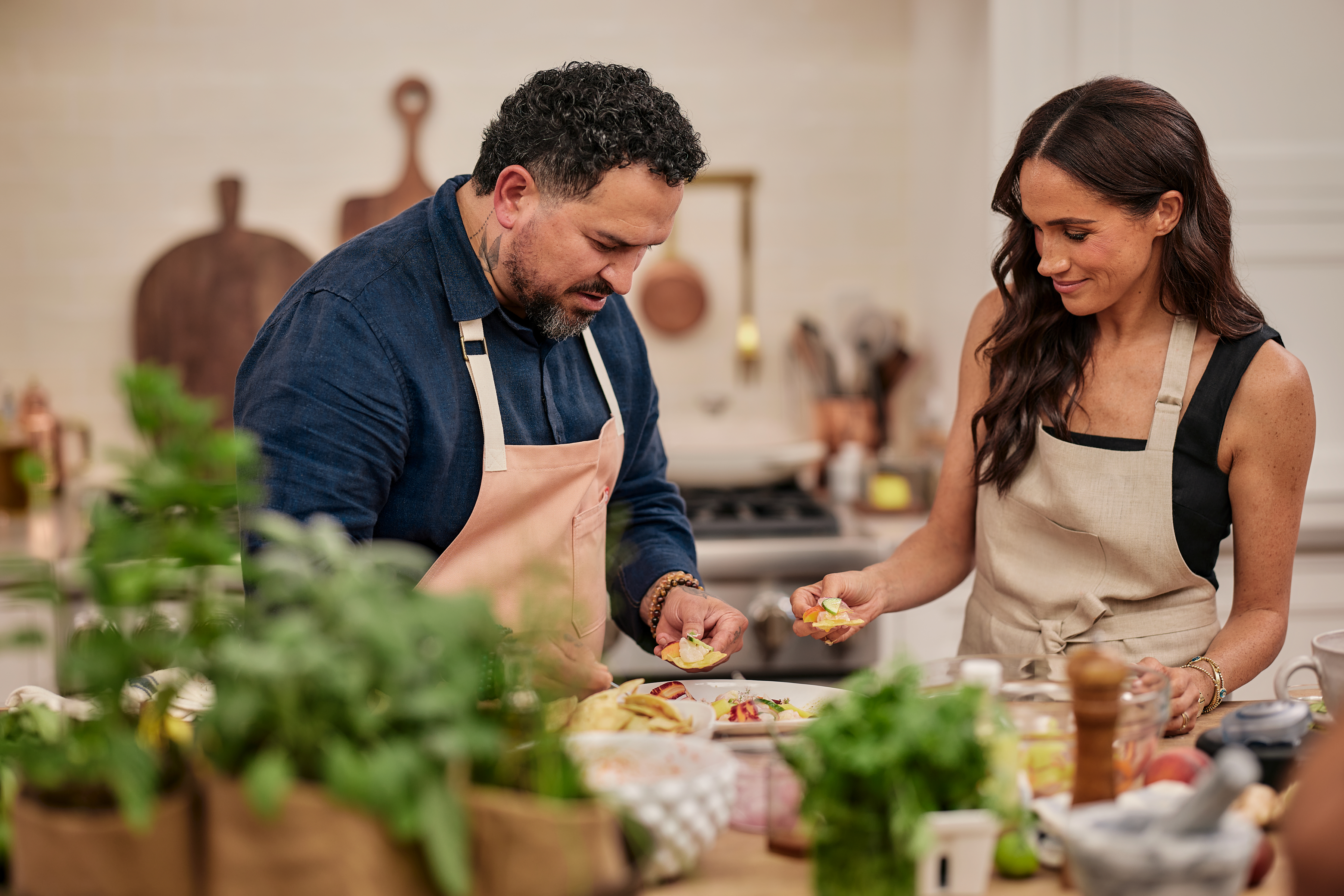 A man and a woman prepre food in a kitchen.
