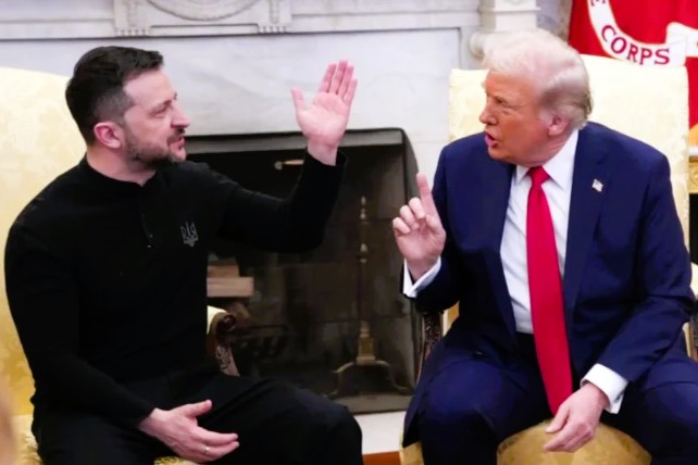President Zelensky raises a hand while President Trump talks at him.