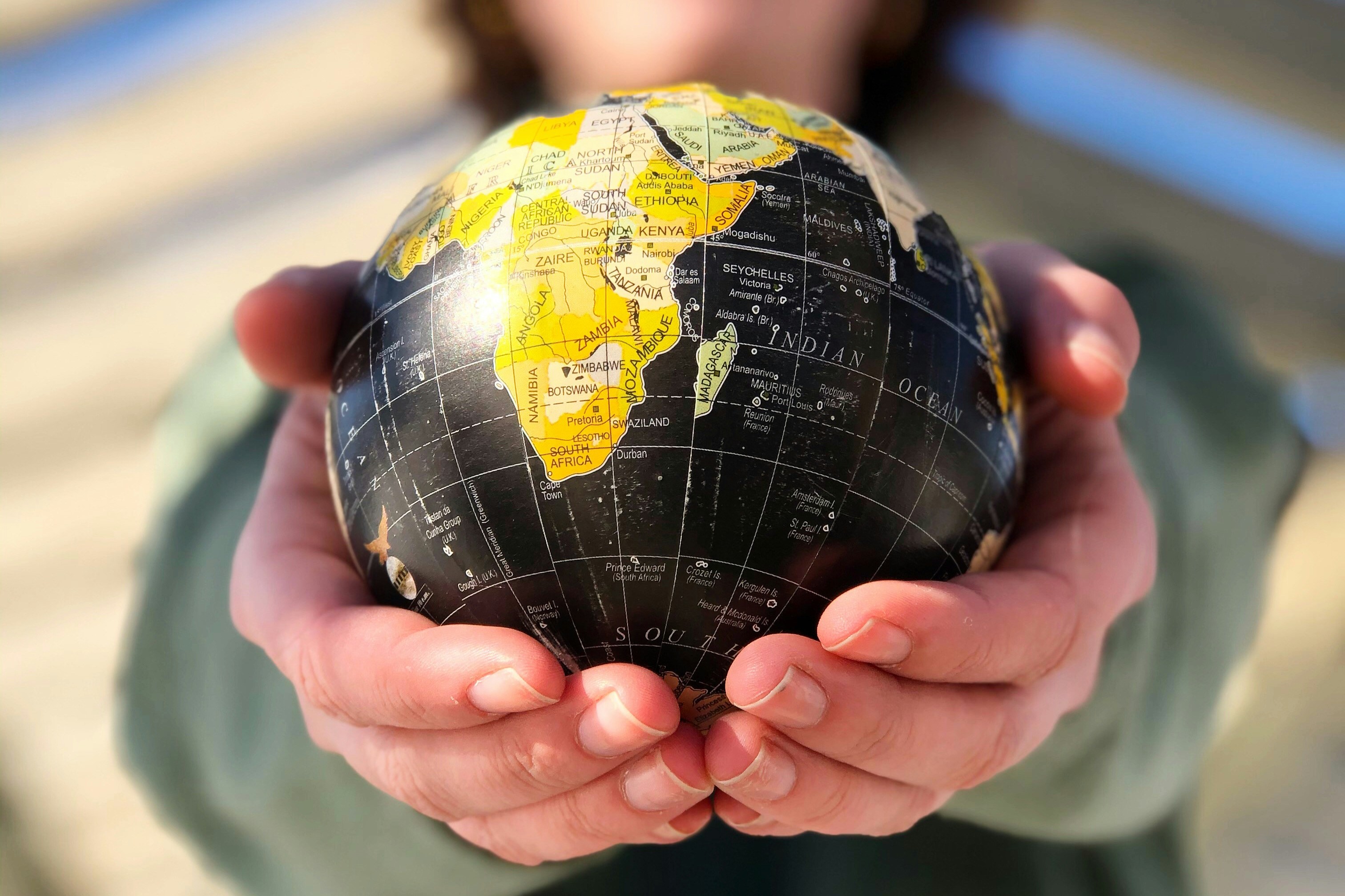 A small globe held in the hands.
