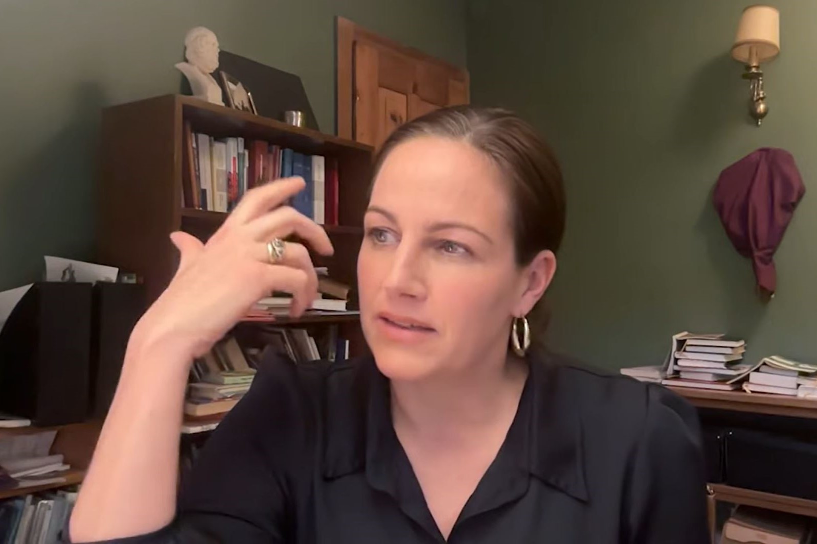 A podcast guest gestures with her hand.