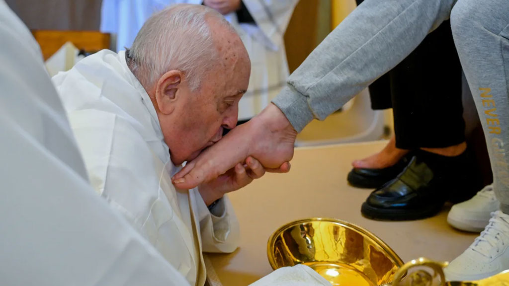 The Pope kisses a foot he has just washed.