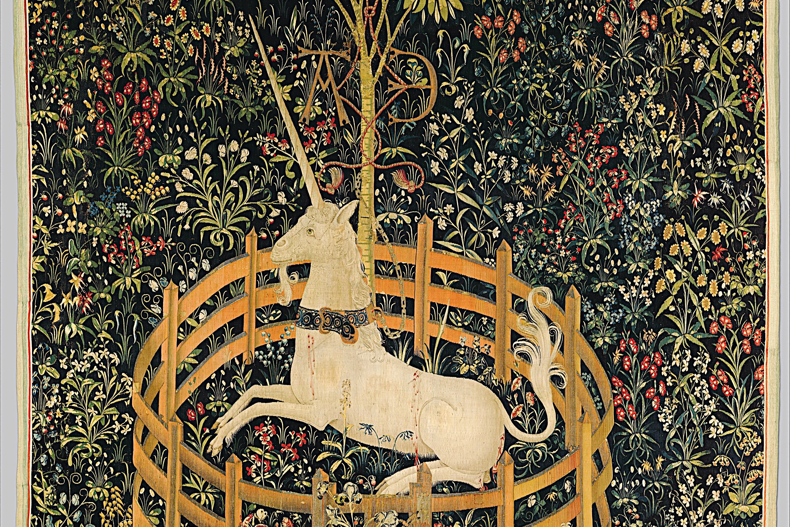A tapestry depicts a unicorn resting within a fenced enclosure.