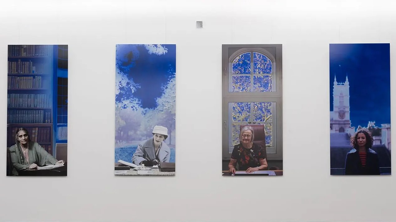 A paiting shows four panels featuring women lawyers over a century