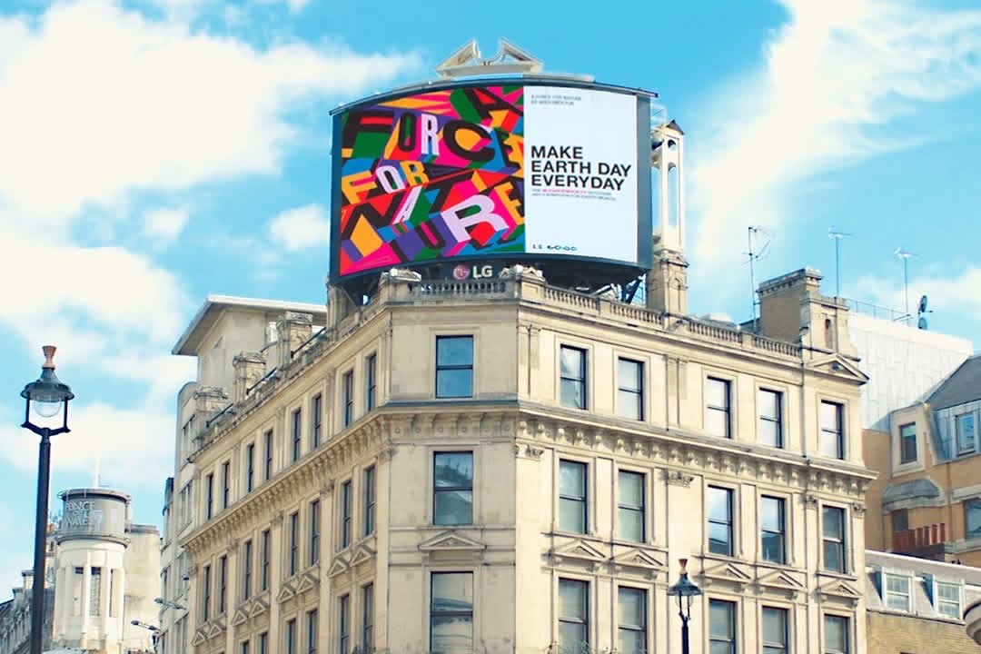 A digital billboard on top of a London building reads: Make Earth Day Everyday.