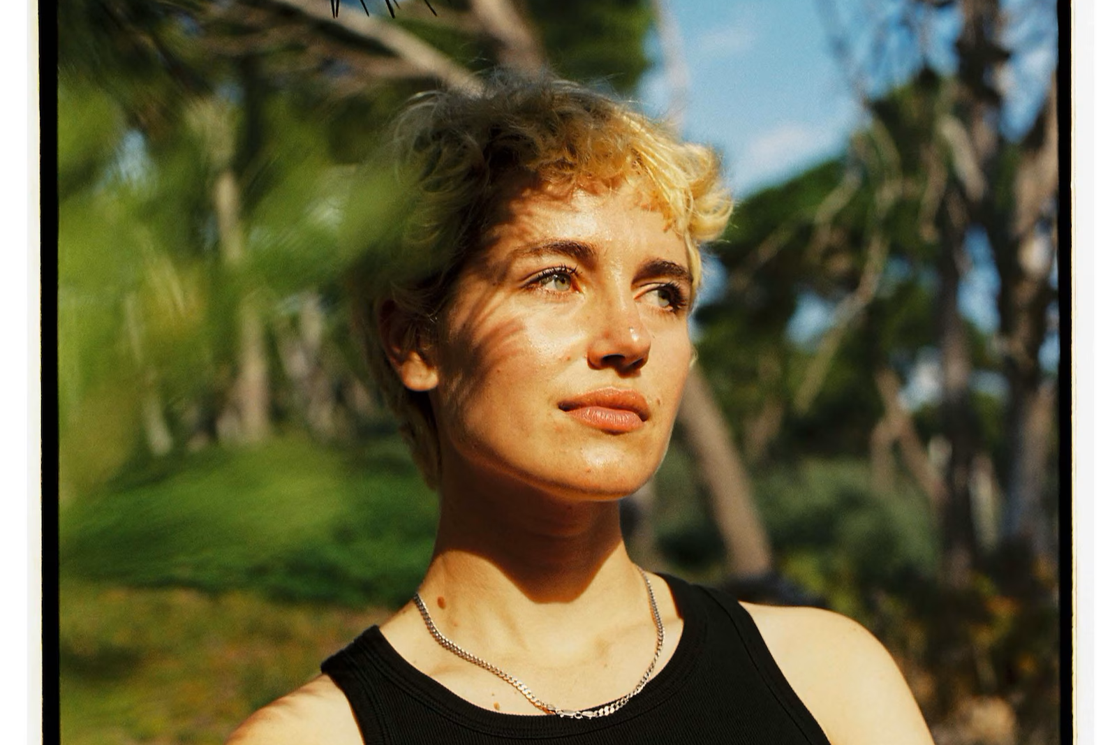 A woman stares away from the camera
