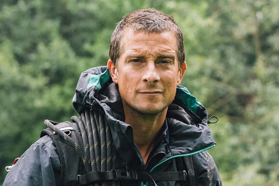 A wet-looking Bear Grylls looks at the camera.