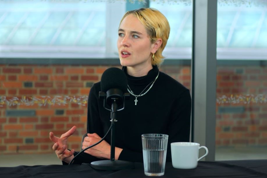 A podcast guest gestures with her hand while talking