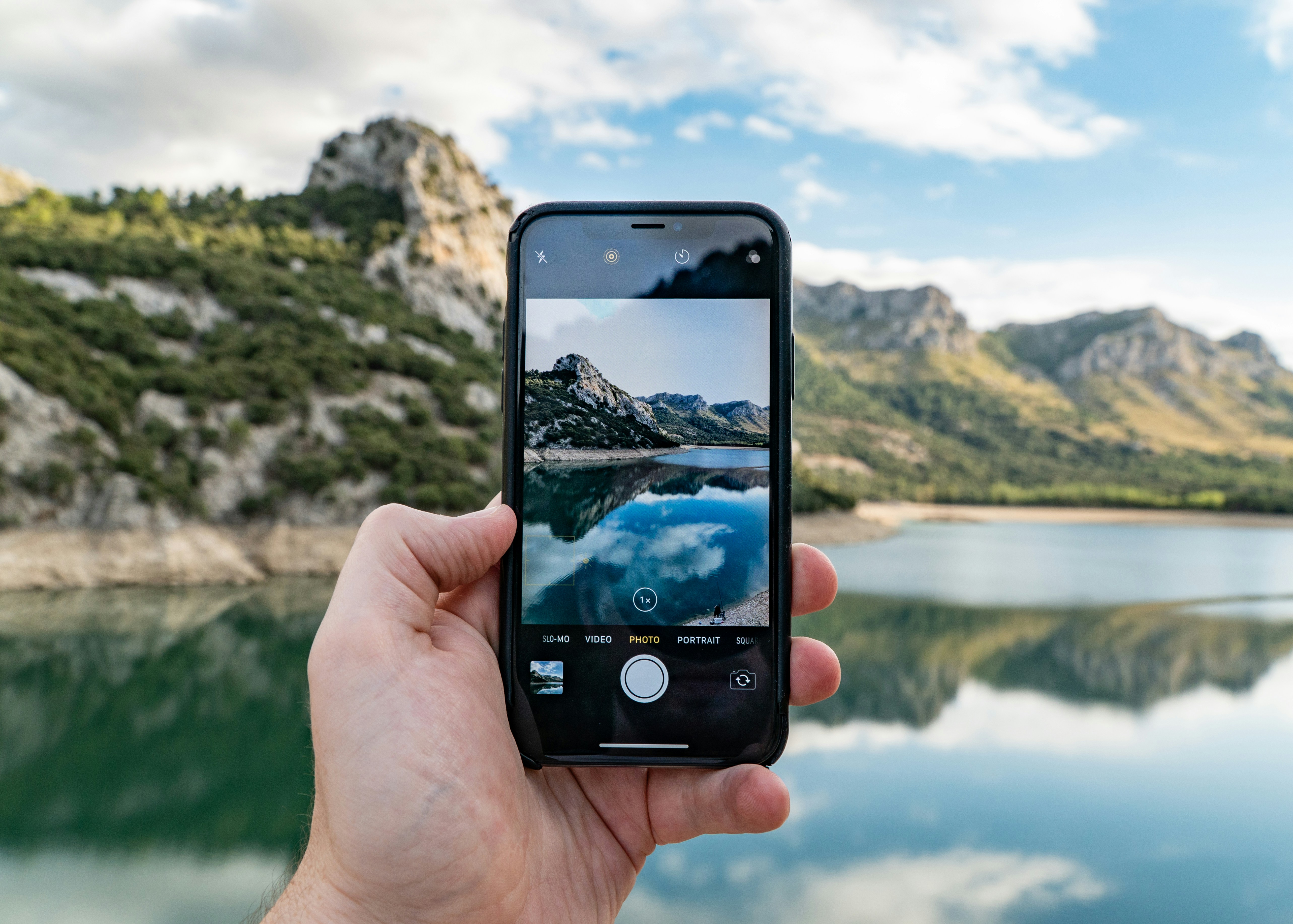 A phone shows a picture of the real view behind it. 