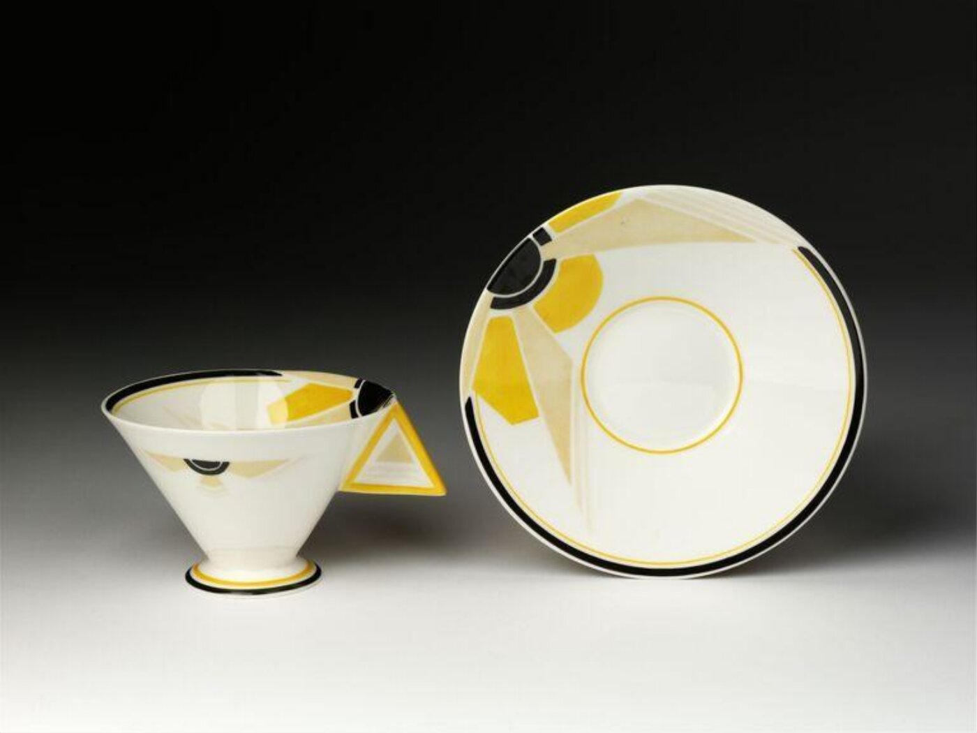 An art deco cup and saucer on display.