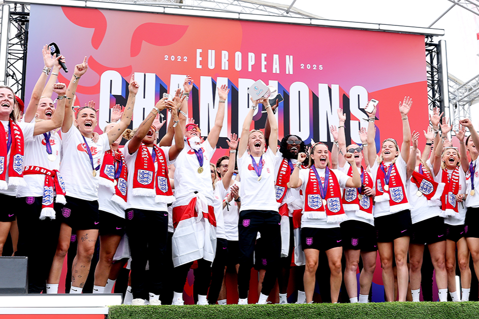 A victorious women's football team celeberate.