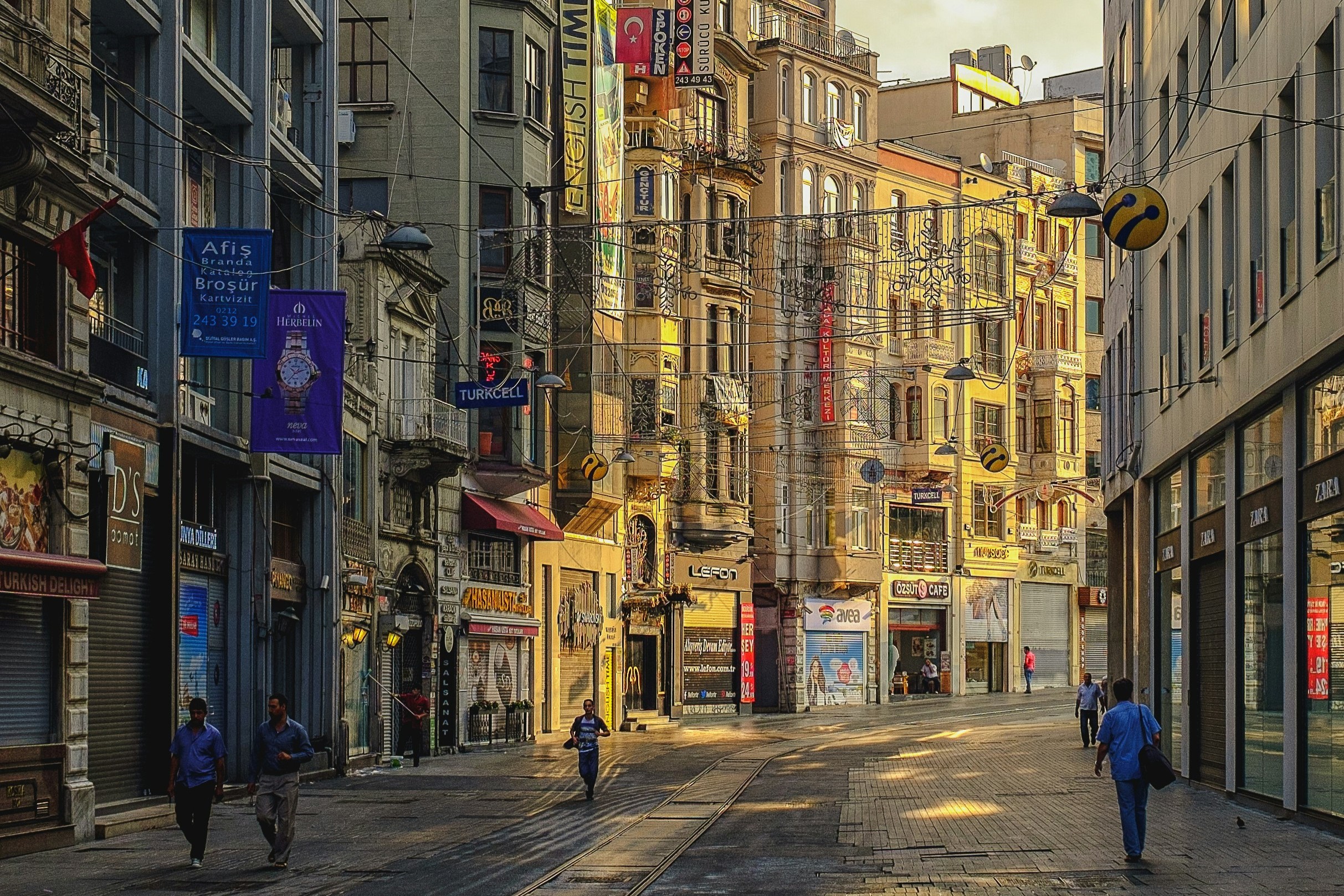 An Istanbul street curves and the sun illuminates one side