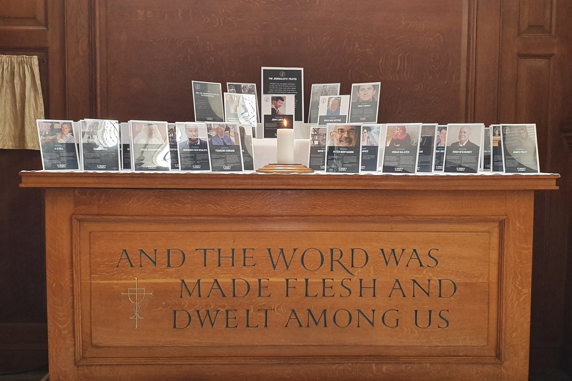A church altar holds commemorative frames of killed journalists
