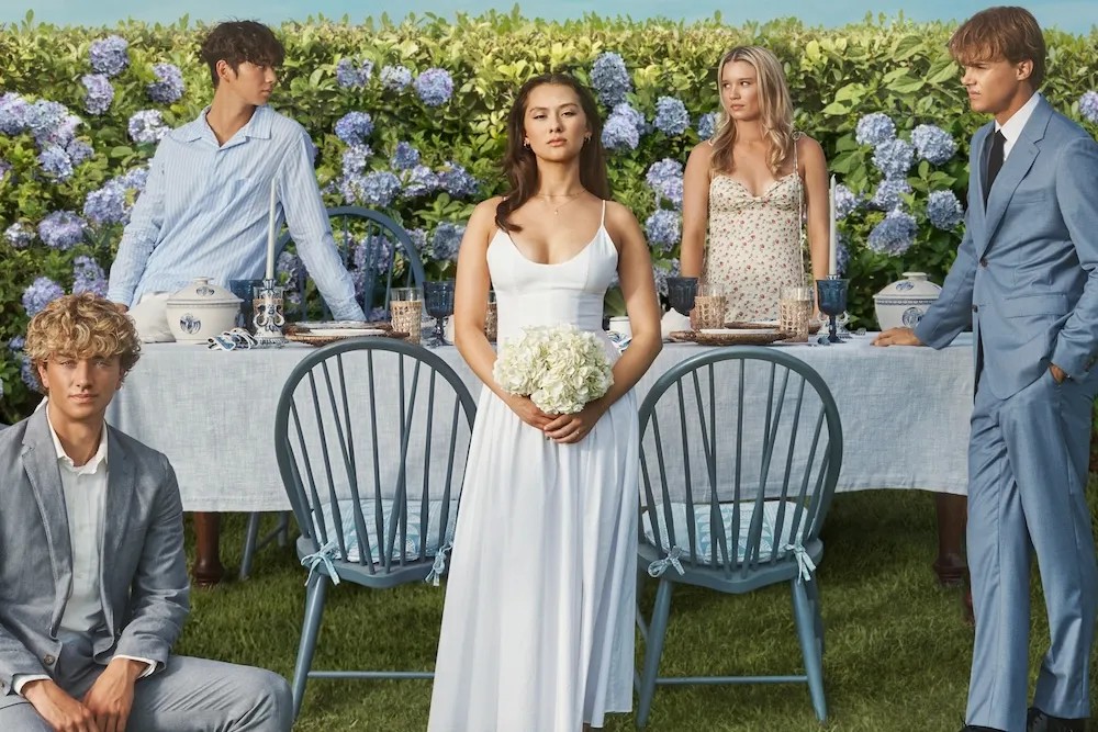 The cast of The Summer I Turned Pretty pose on a wedding set.
