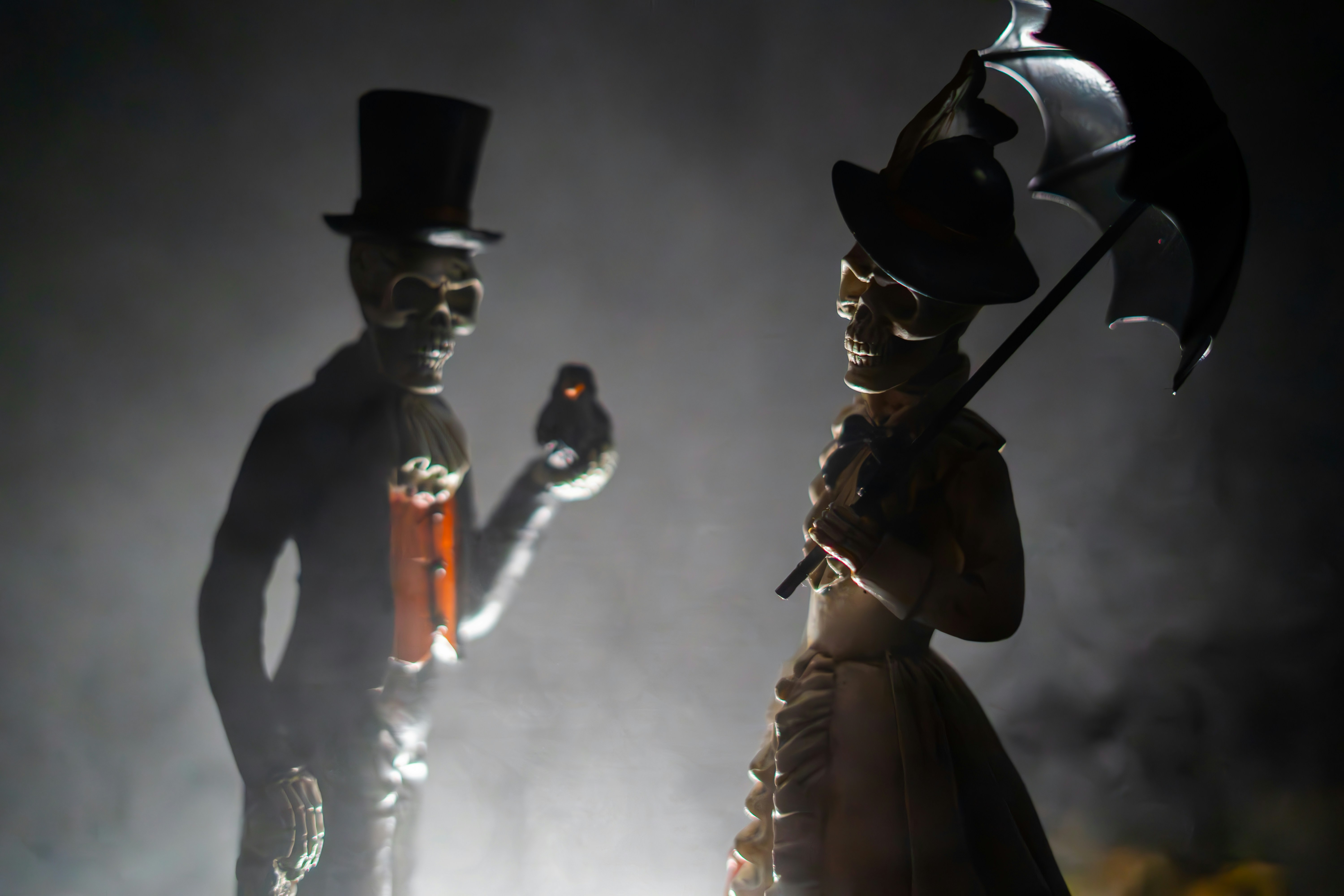 Skeleton figurines clothed in Victoria outfits.