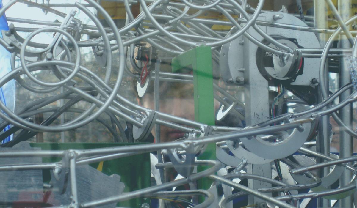 A complex of linear and metal parts in a machine-like sculpture.