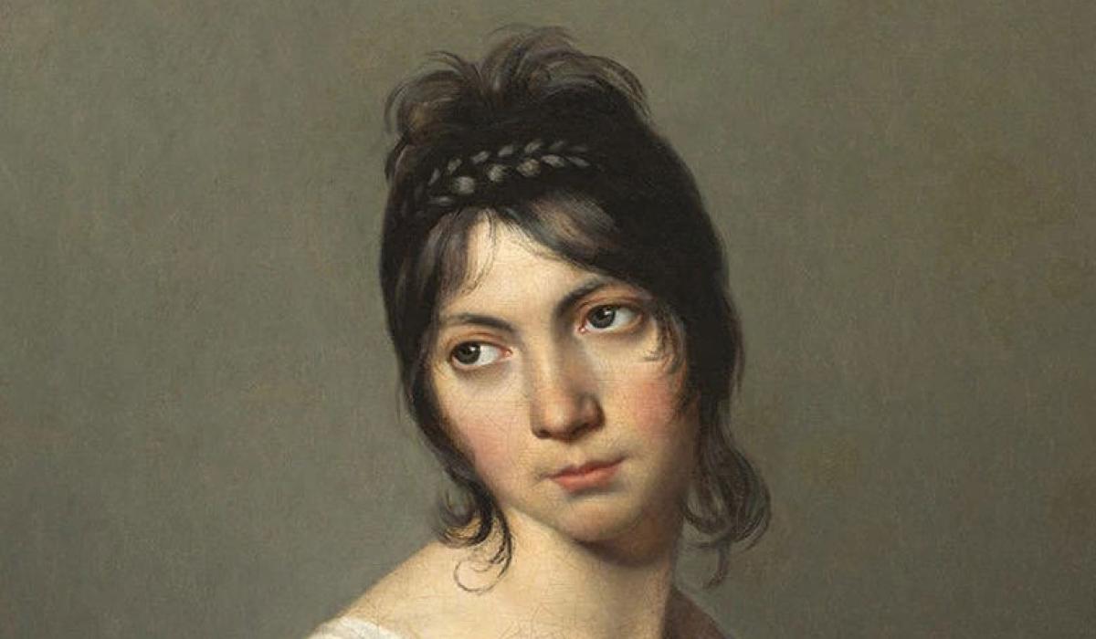 A head and shoulders portrait of a young woman inclining her gaze to one side.