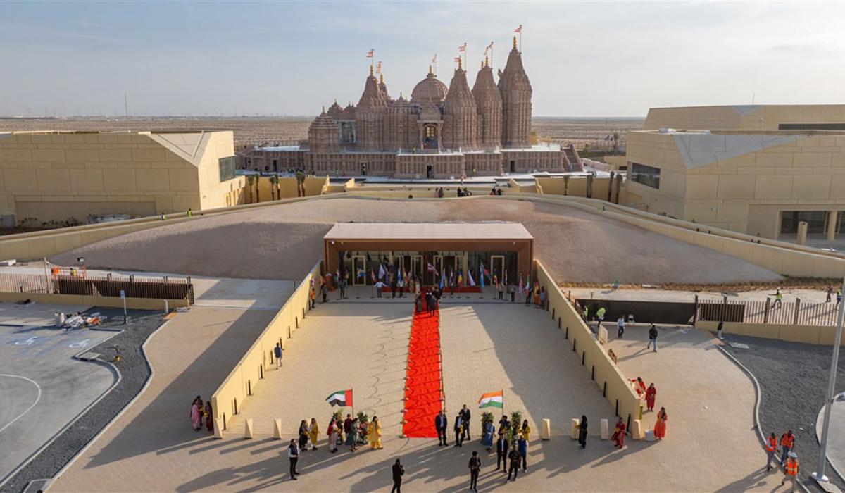 A red carpet lies on a grand entrance to a newly constructed Hindu temple.