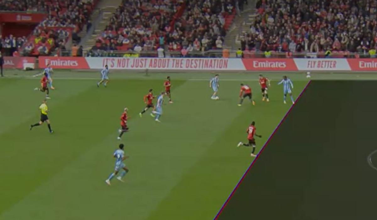 A TV screen shows a football match with a superimposed diagonal line dividing the pitch.