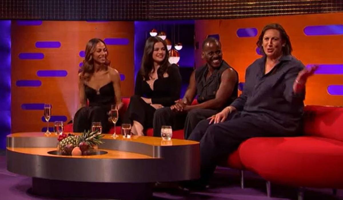 On a TV chat show, guests look to one of their own talking to the audience. 