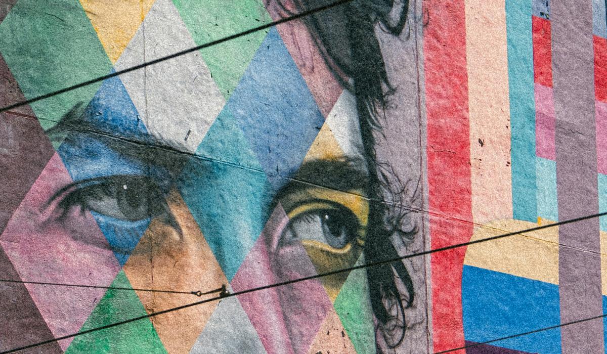 A colorful mural depicts the eyes of Bob Dylan staring to the side.