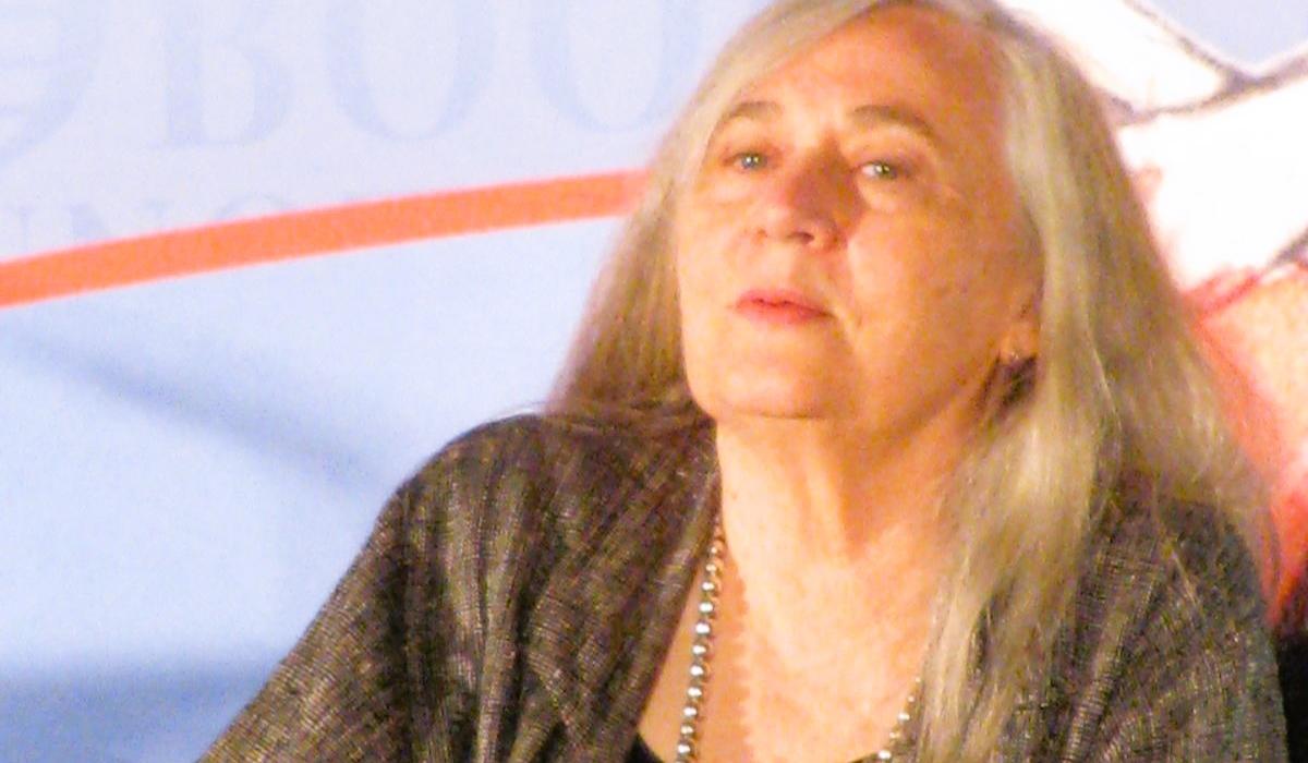 An author sits and listens.
