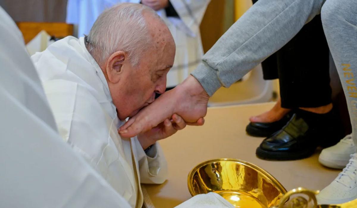 The Pope kisses a foot he has just washed.